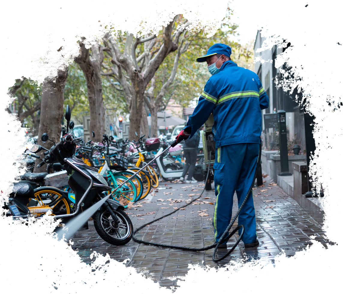 A man in blue jacket and cap holding hose.