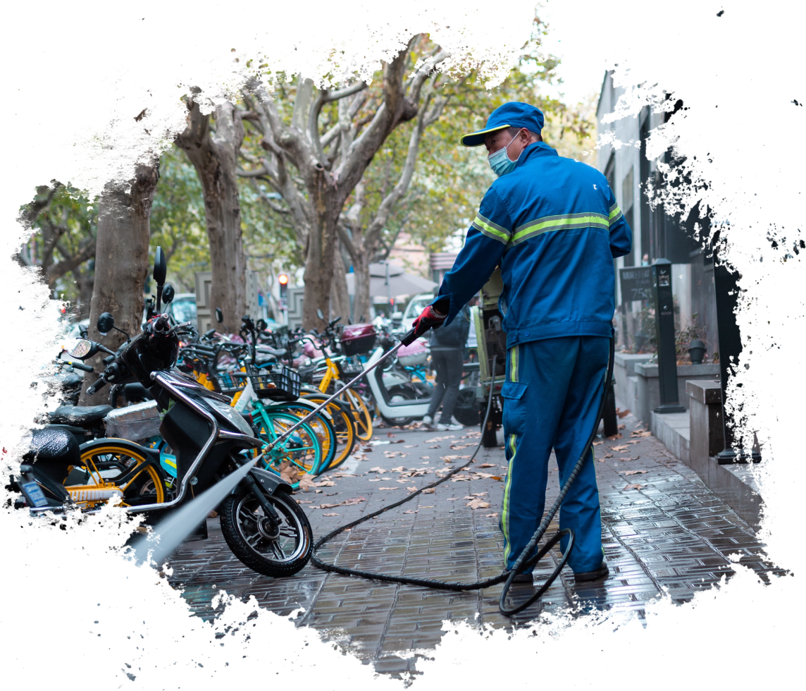 A man in blue jacket and cap holding hose.